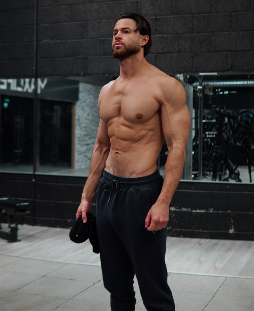 Coach displays his upper body muscles.